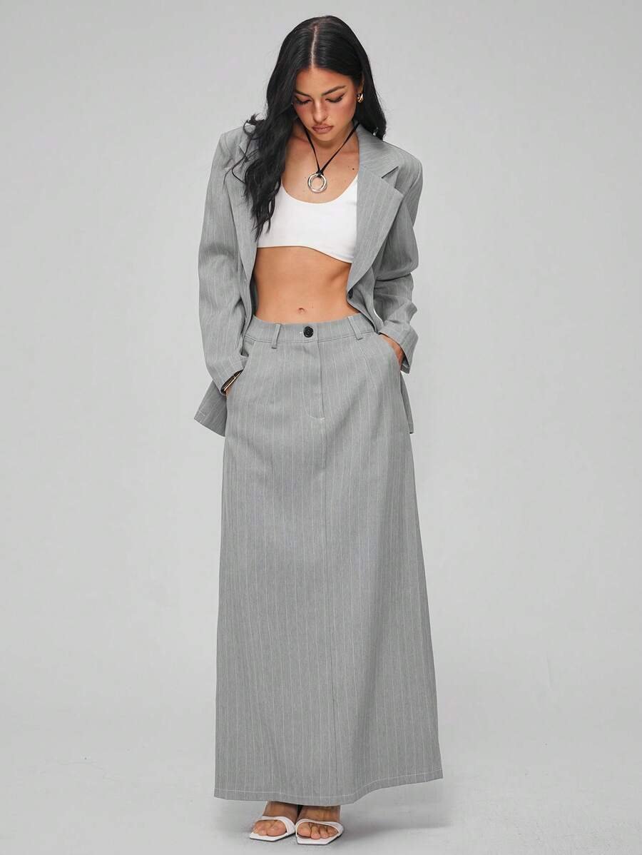 Woman in the Cotiful grey pinstripe skirt suit with a white top