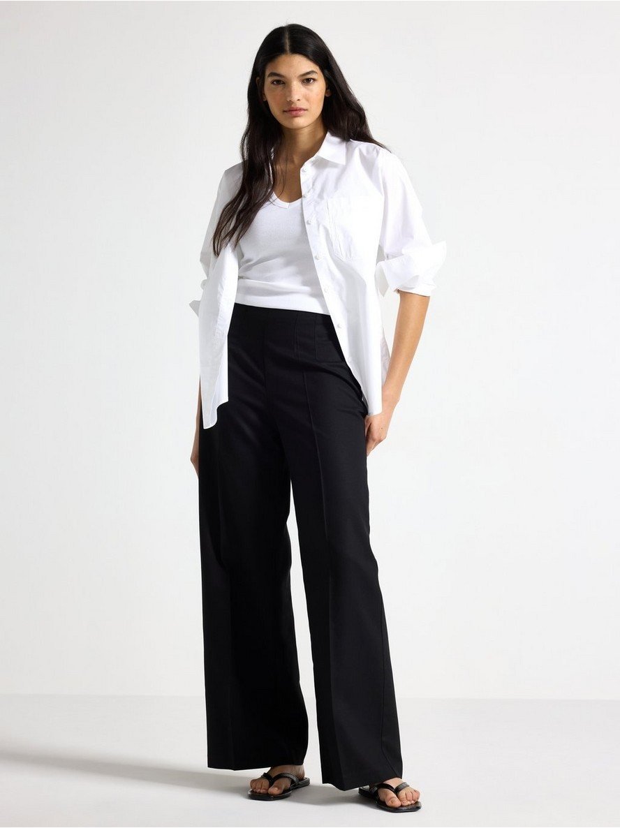 Black pintuck wide-leg trousers by Cotiful